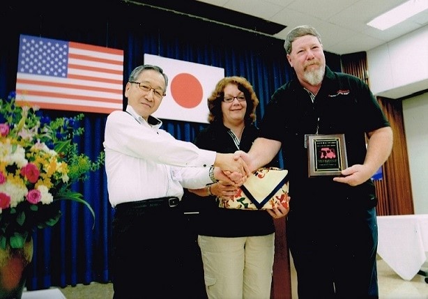 Brad (Owner and President) and Kim (Sales and Administration) Dunlap receiving the Samurai Award for outstanding Sales and Service from Mahindra in 2014